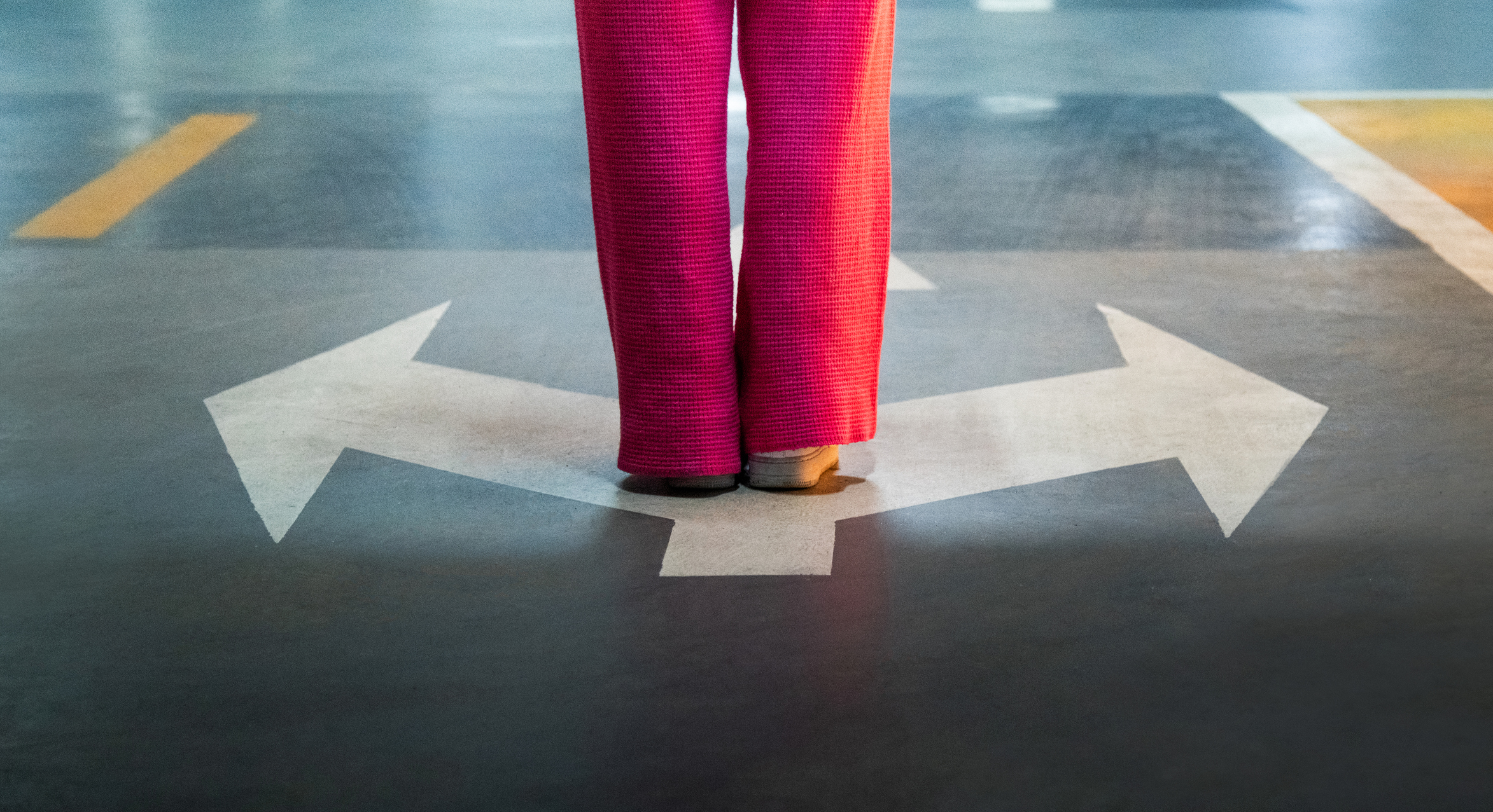 Woman standing in front of three arrows showing different ways